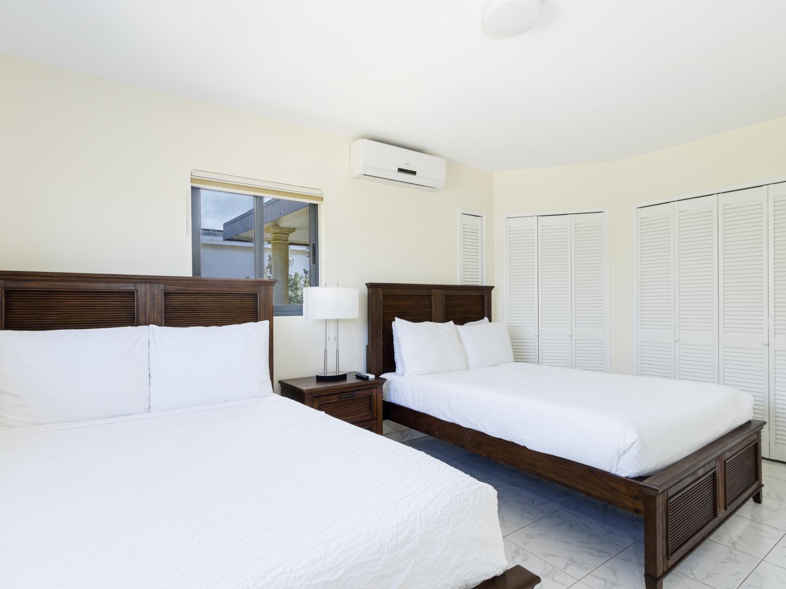 Resplendent Bedroom of the Villa in Noord Aruba - Two plush Queen size twin beds - Bedroom with a cozy ambiance, blending comfort and aesthetics - Modern and stylish decor that complements the space