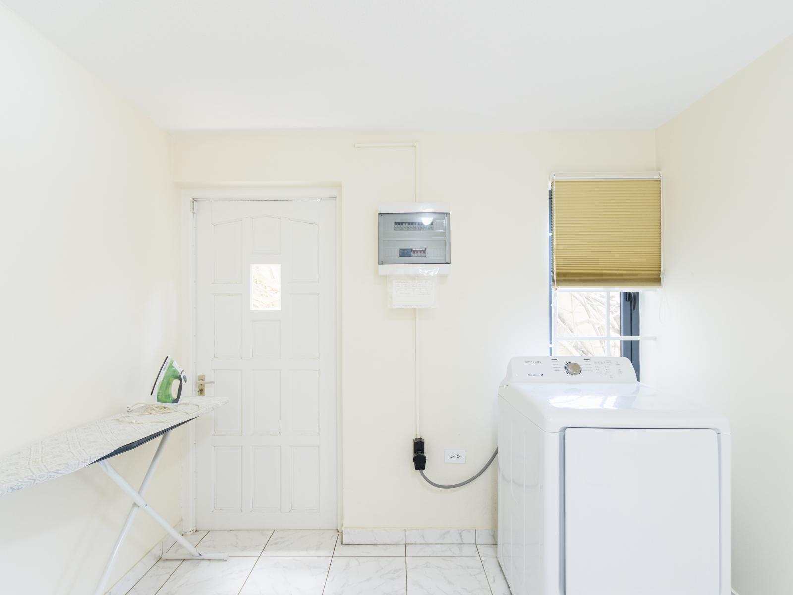 Clean laundry room of the Villa in Noord Aruba - Step into our laundry room - Equipped with a washer and dryer - Chores become a breeze amidst convenience and comfort