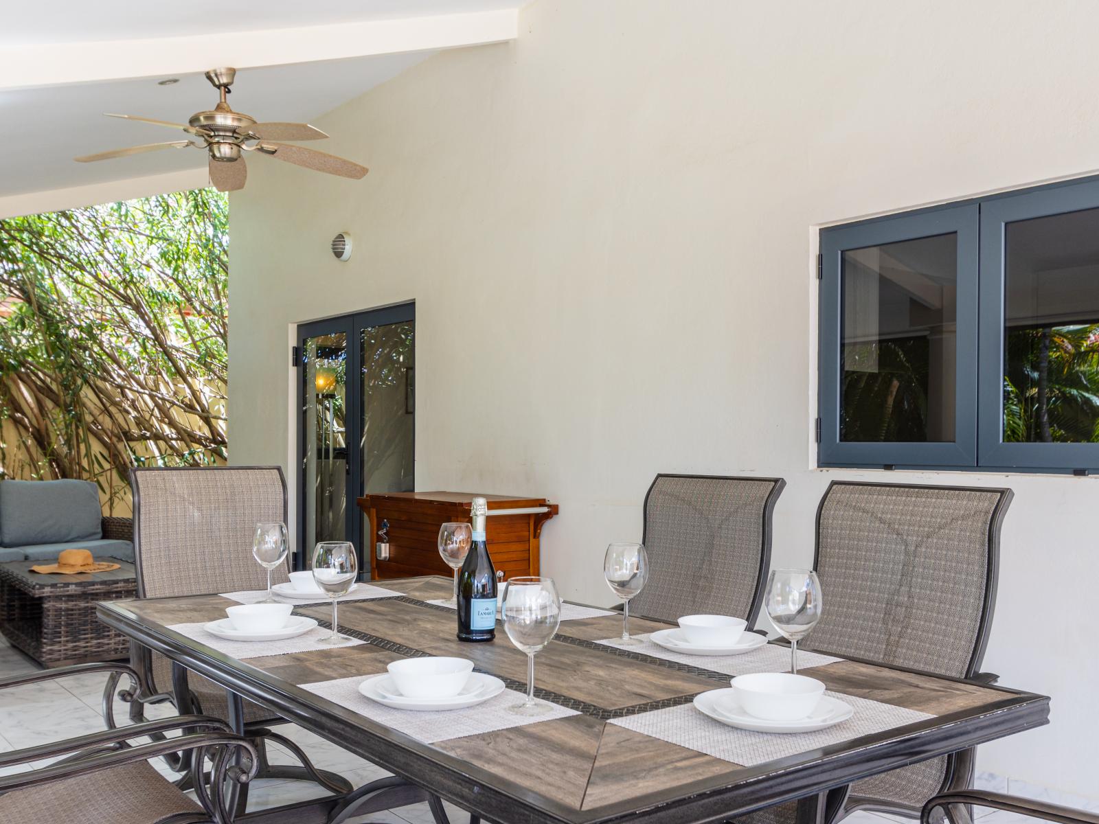 Outside dining table of the Villa in Noord Aruba - Elevate your dining experience amidst the beauty  - Experience outdoor bliss with our charming dining - From brunch to dinner, it sets the perfect scene