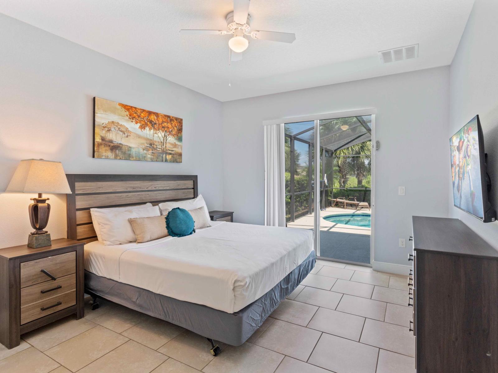 Chic bedroom of the home in Davenport Florida - Modern design meets cozy relaxation - Well-appointed bedroom with neutral tones for a calming atmosphere - Access to outdoors with pool - Smart TV for entertainment