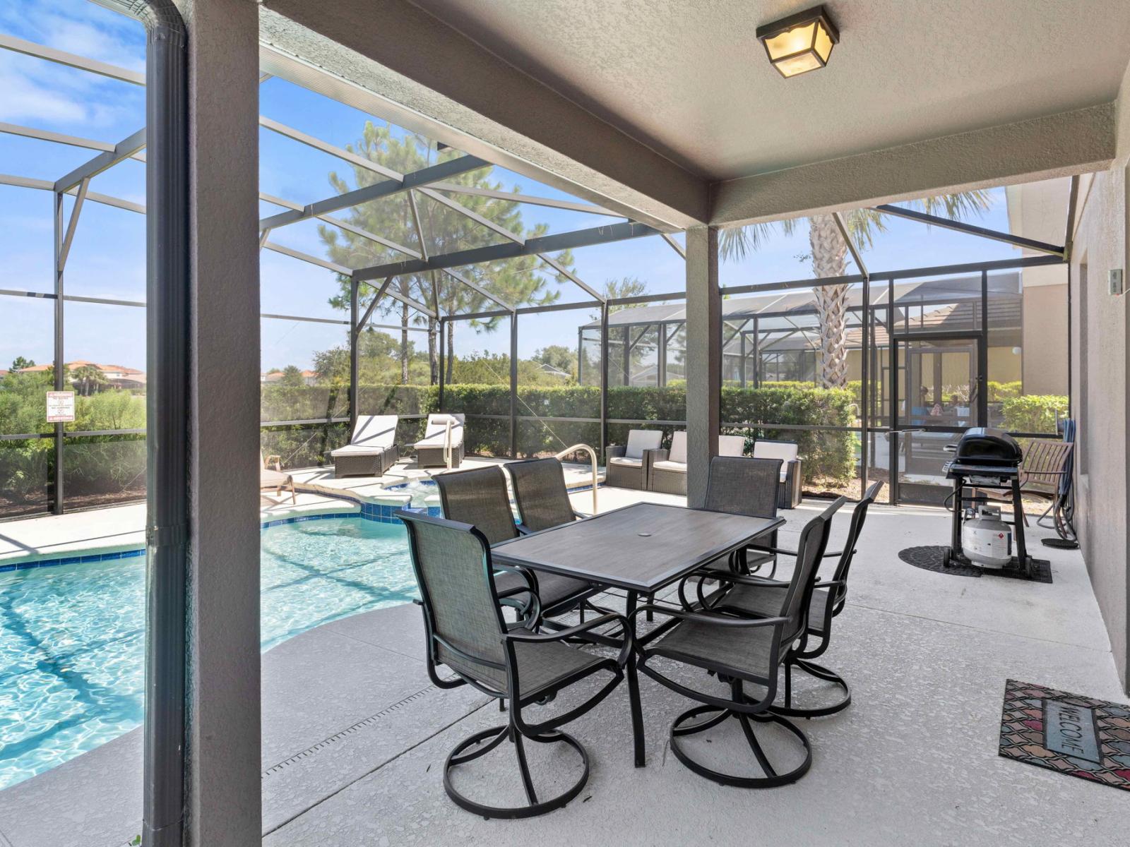 Lush outdoor dining area of the home in Davenport Florida - Outdoor dining experience offers a feast for the senses - Every meal accompanied by stunning pool views - Spice up the flavors with BBQ grill