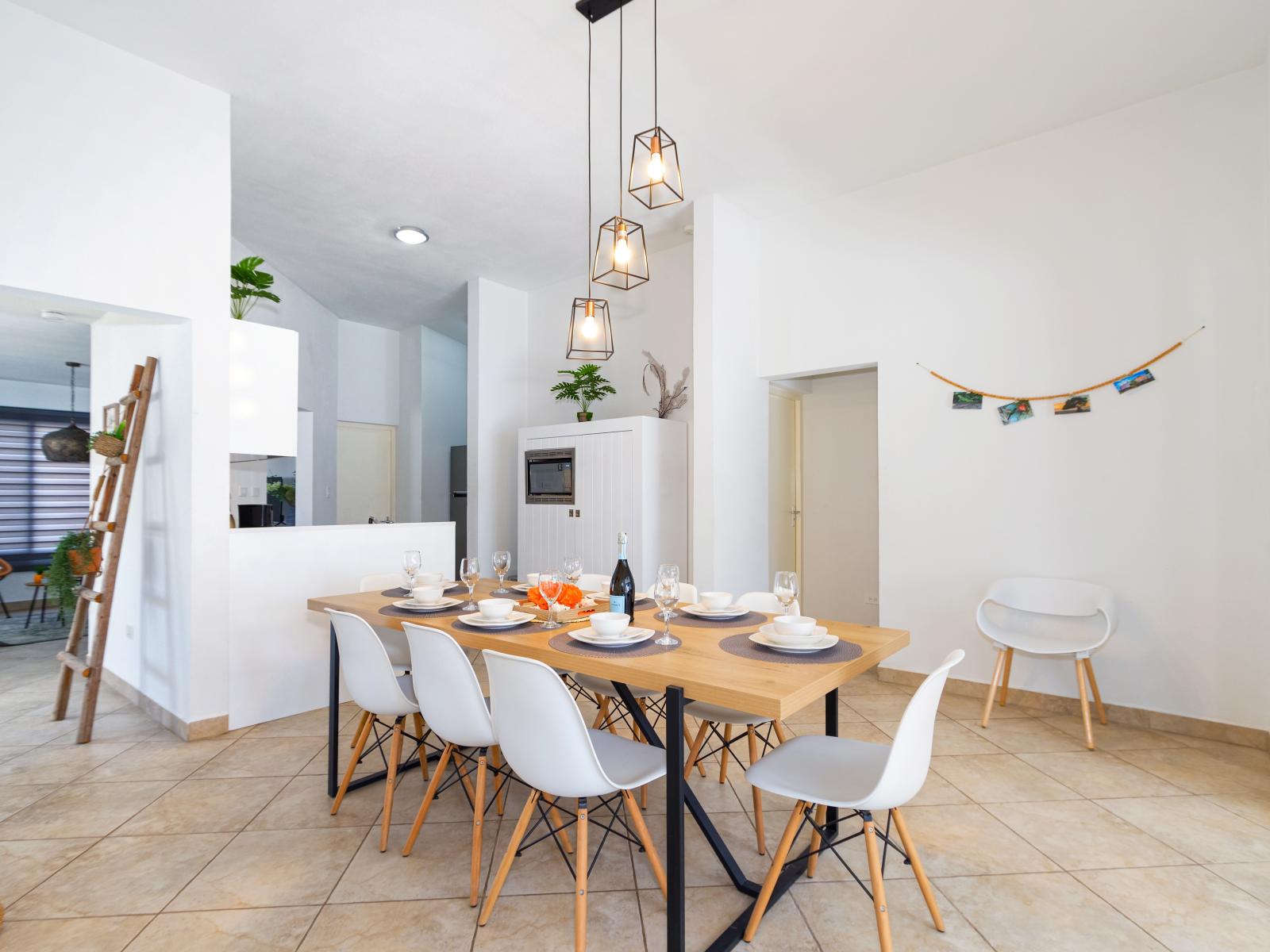 Lush Living and Dining Area of the 3BR house in Noord Aruba - Open-concept living area seamlessly connected to a stylish dining space - 8 Persons Dining - Cohesive design aesthetic carried through from furniture to window treatments