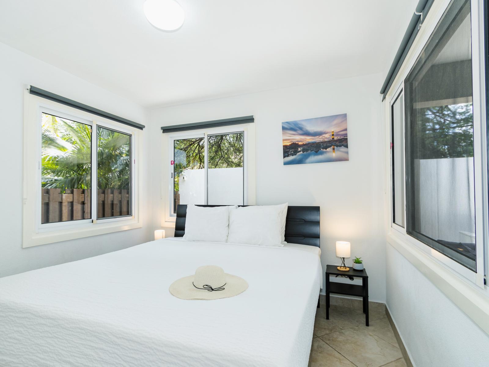 Classy Bedroom of the 3BR house in Noord Aruba - Stunning outside views - Comfy Queen Size Bed - Bright and airy bedroom with large windows for natural illumination