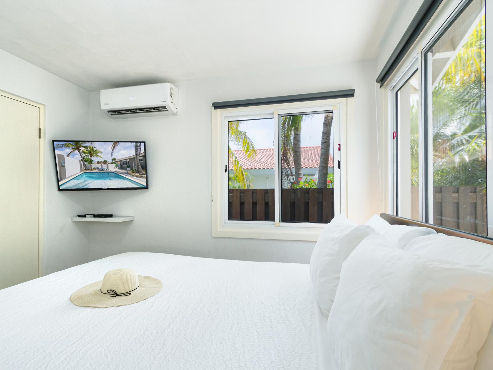 Exquisite bedroom of the villa in Noord, Aruba - Comfy king size bed - Elegantly designed room with beautifully located double side widows - Completely bright bedroom - Majestic table lamps - Neat and clean linen - Availability of TV and Netflix