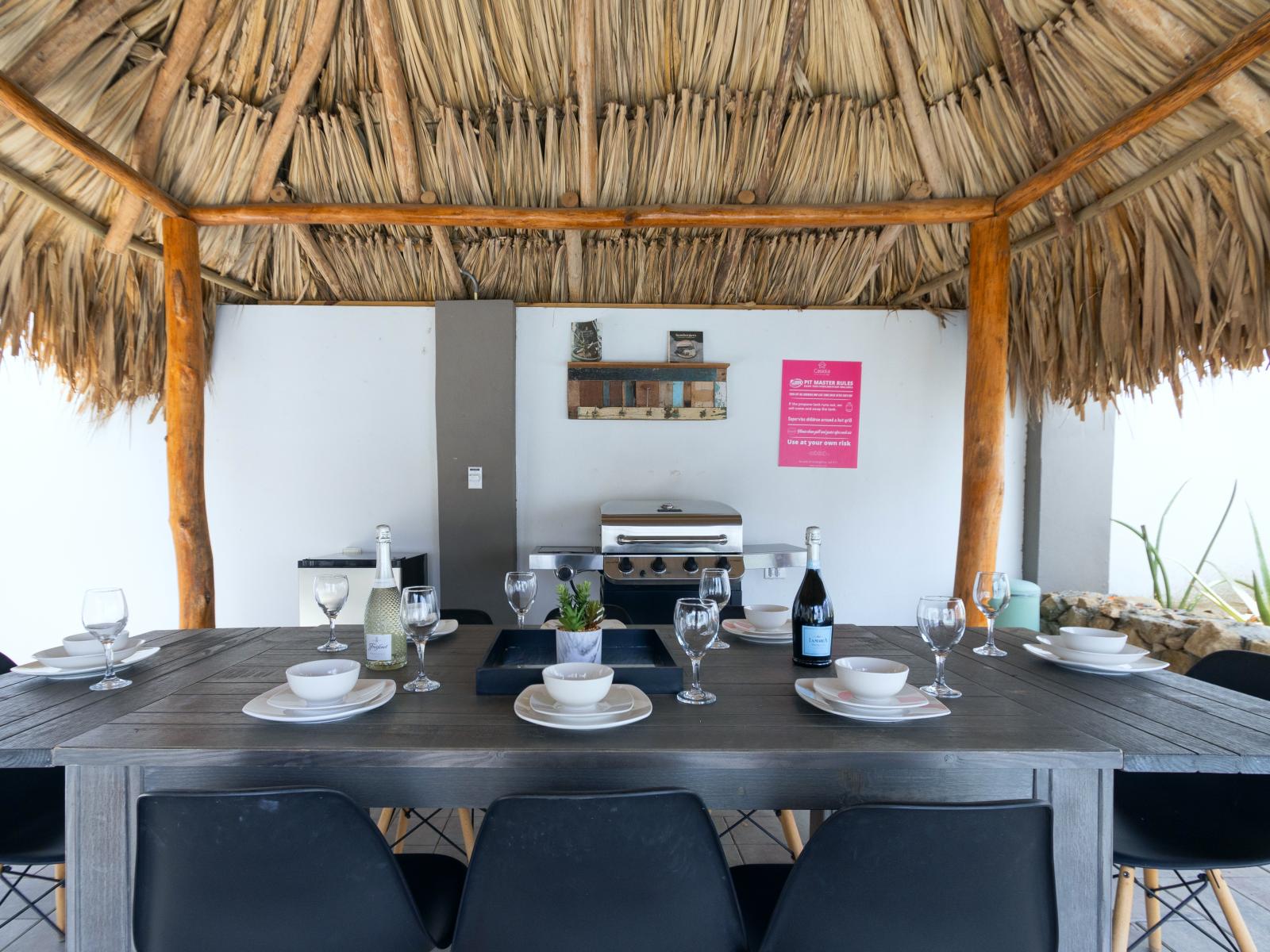 Outside palapa poolside dining area of the 3BR house in Noord Aruba - 8 Persons Dining - Outdoor dining experience offers a feast for the senses - Every meal accompanied by stunning pool views