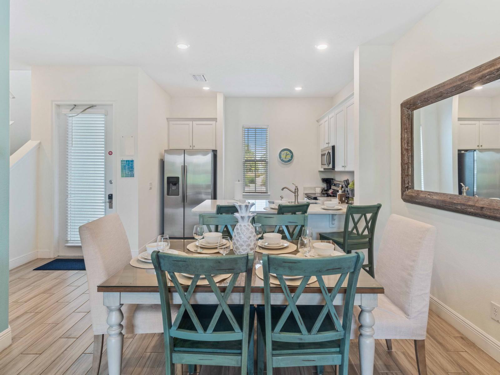 Sleek dining area of the townhouse in Reunion Florida - Six seating capacity - Artfully arranged table settings for a touch of elegance - Sophisticated design with a blend of modern and classic elements