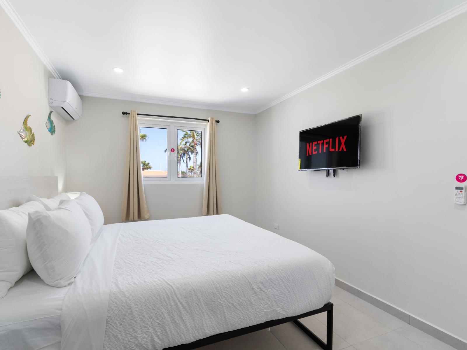 Bedroom 1 features a King bed, smart TV and an en-suite bathroom