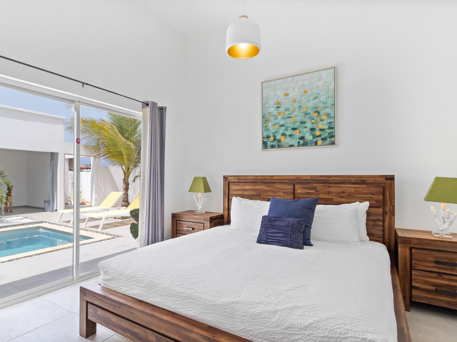 Premium Bedroom of the home in Noord Aruba - Indulge in regal relaxation - Minimalistic Approach giving clean space to relax - Bedroom boasts a king bed - Direct access to the pool