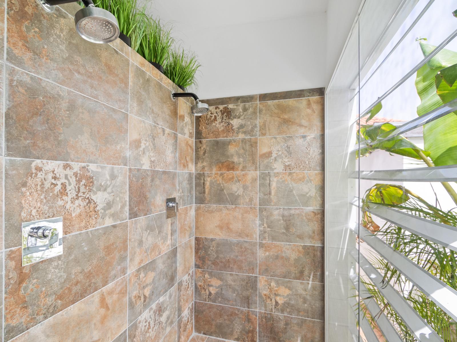 High-end bathroom of the home in Noord Aruba - Offers a walk in shower - Sophisticated color palette creating a serene ambiance