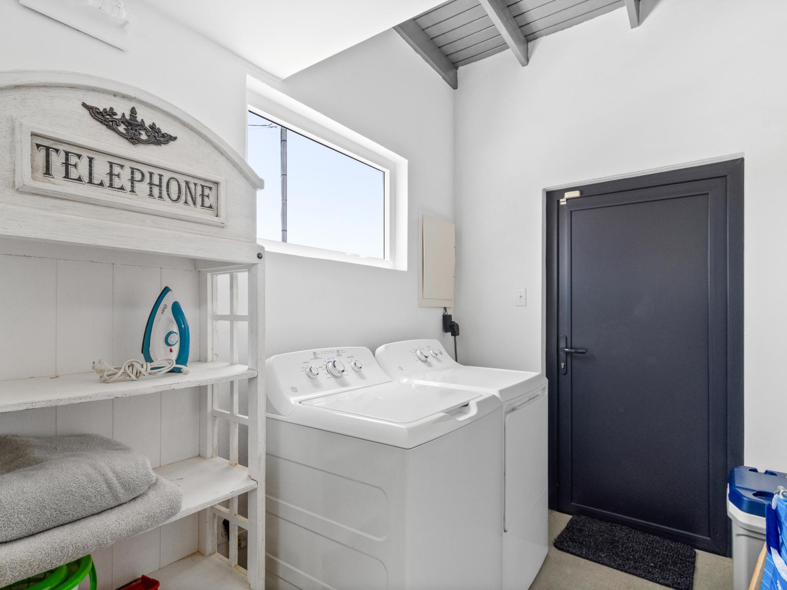 Clean laundry room of the home in Noord Aruba - Step into our laundry room - Equipped with a washer and dryer - Chores become a breeze amidst convenience and comfort