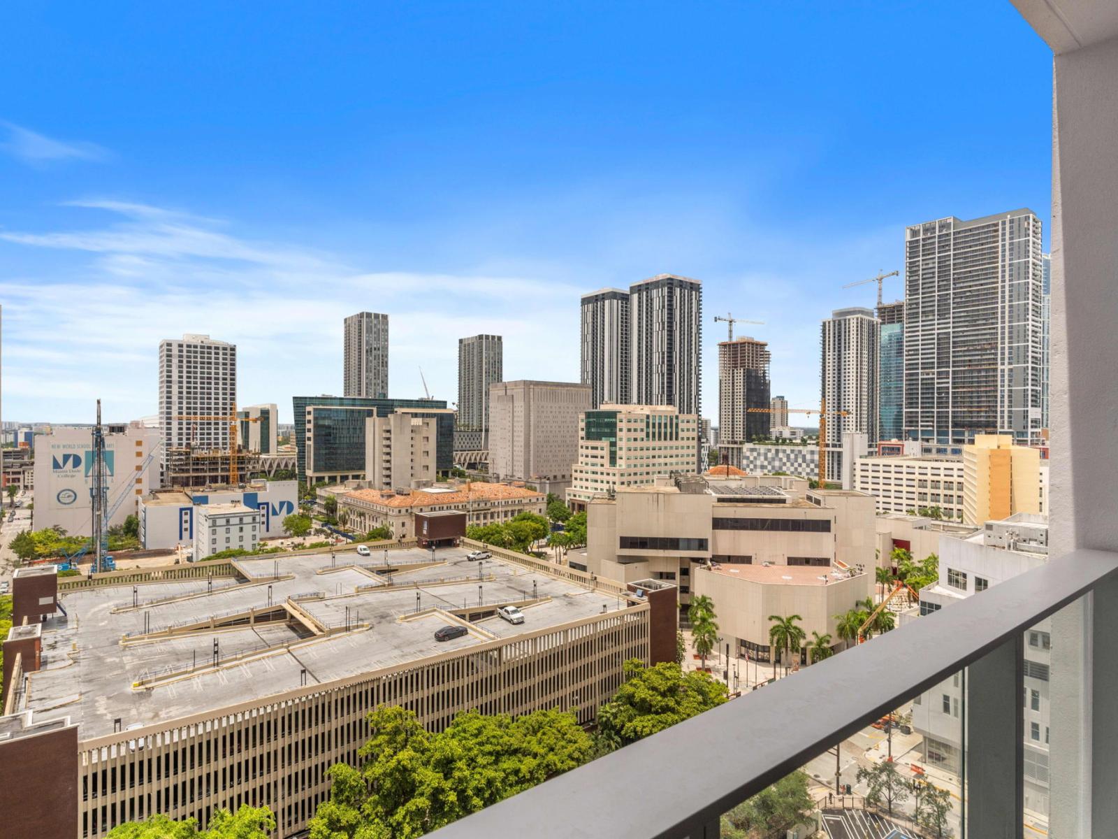 Whispering Winds: Embrace Romance on Our Juliet Balcony, Offering Mesmerizing Views of Miami's Glittering Skyline, Perfect for Intimate Moments.