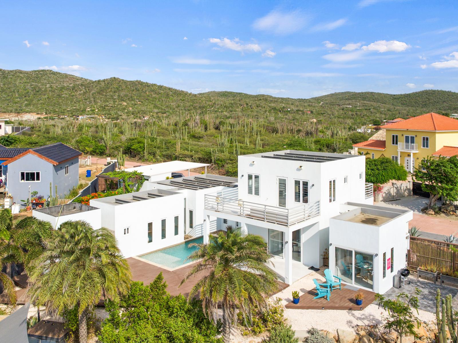 Stunning view showcasing the luxury vacation home - Inviting pool area - The lush natural surroundings of San Fuego - Greenery everywhere