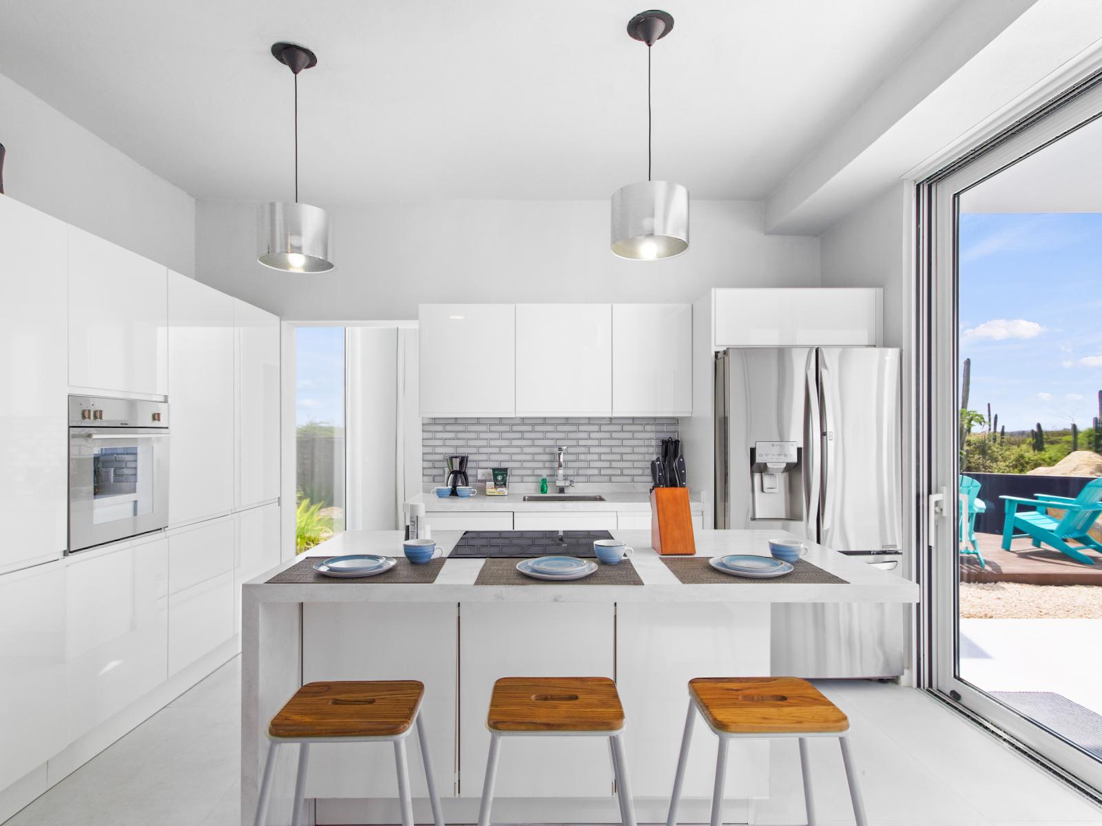 Modern Kitchen of the vacation home in Aruba - Fully Equipped - Breakfast Bar with chairs - Modern kitchen with sleek, stainless steel appliances