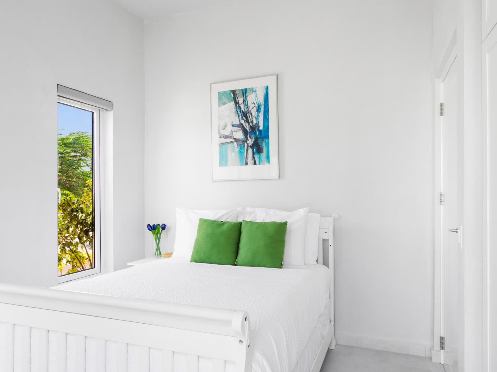 Elegant Bedroom of the vacation home in Aruba - A full size bed - Indulge in regal relaxation - Minimalistic Approach giving clean space to relax