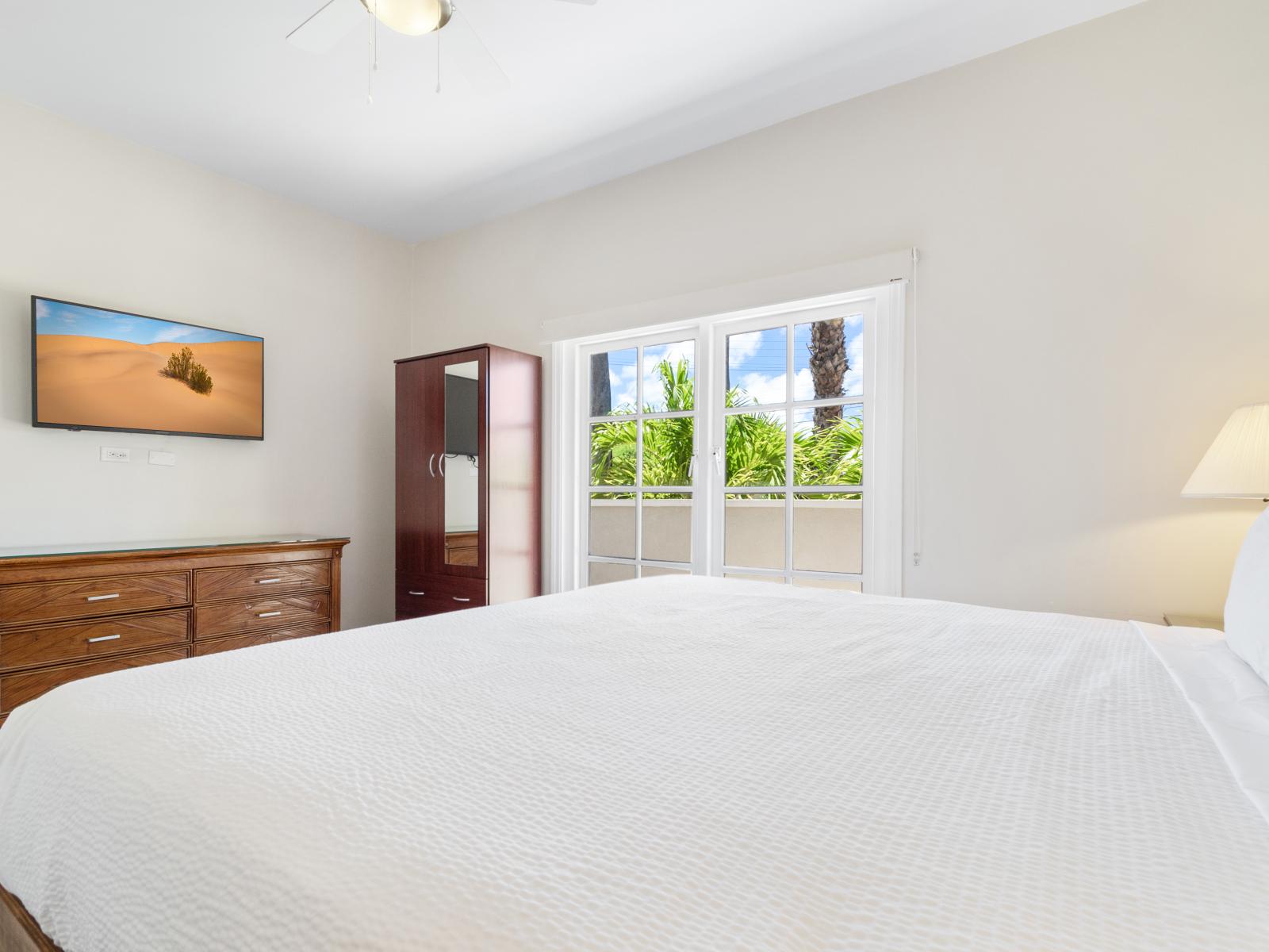 Bedroom 2 with a wall-mounted flat-screen Smart TV for your entertainment.