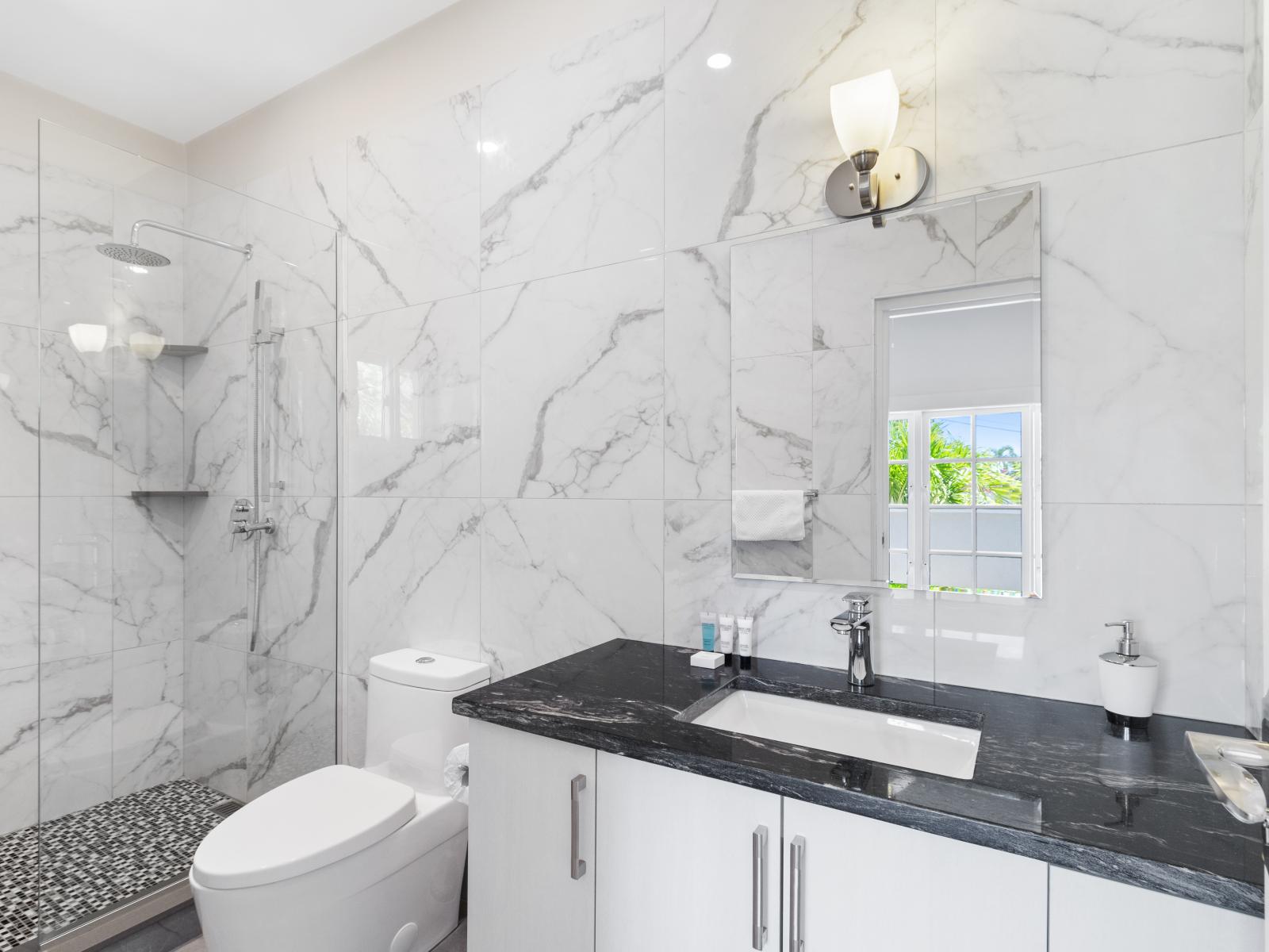 Splendid Bathroom of the Villa in Noord Aruba - Elegant bathroom with luxurious fixtures and finishes - Attention to detail, from the elegant tiles to the faucets - Seamless design featuring a glass-enclosed shower for a modern touch