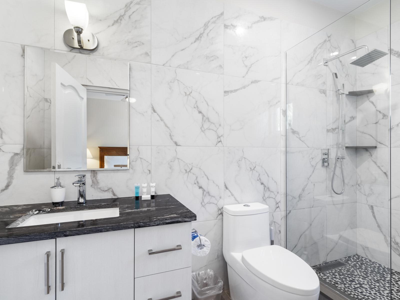 Indulge in comfort and style in the third bedroom's bathroom, complete with a modern walk-in shower