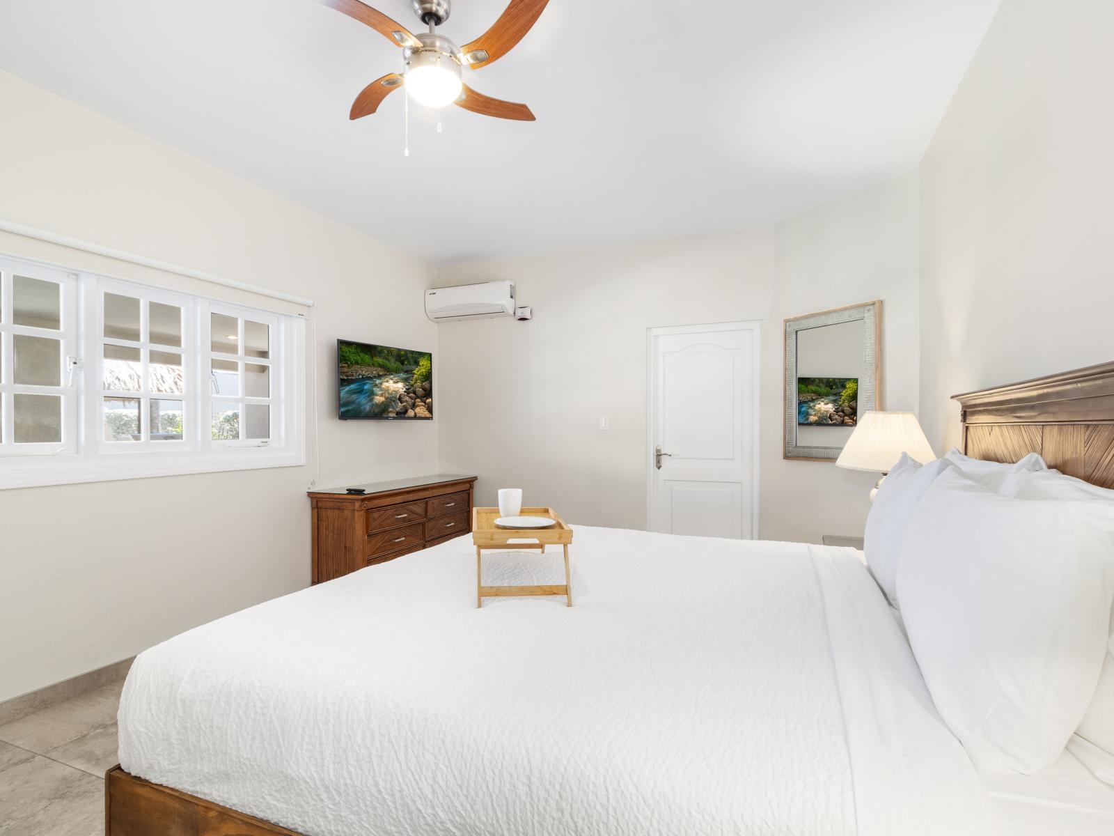 Your haven awaits: the fourth bedroom features a spacious king bed, perfect for unwinding after a day of adventure.