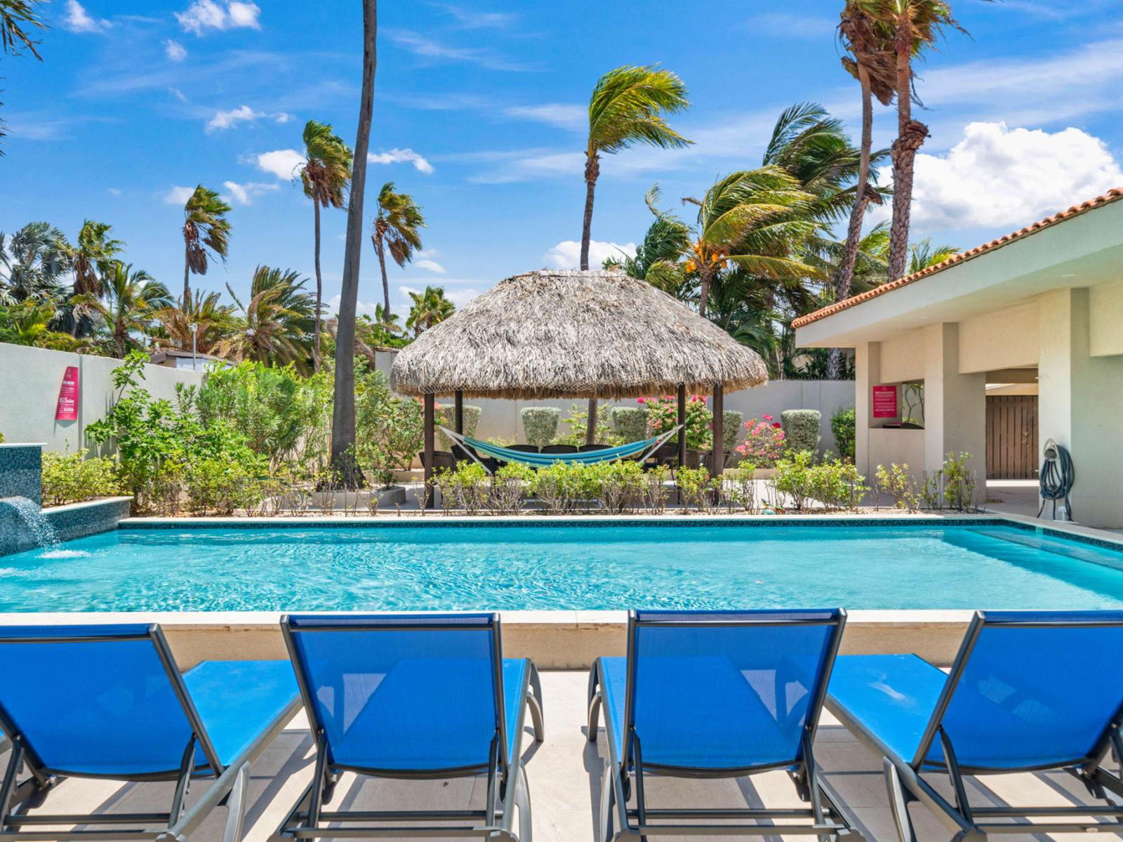 Abundant poolside chairs for sunbathing and relaxation.