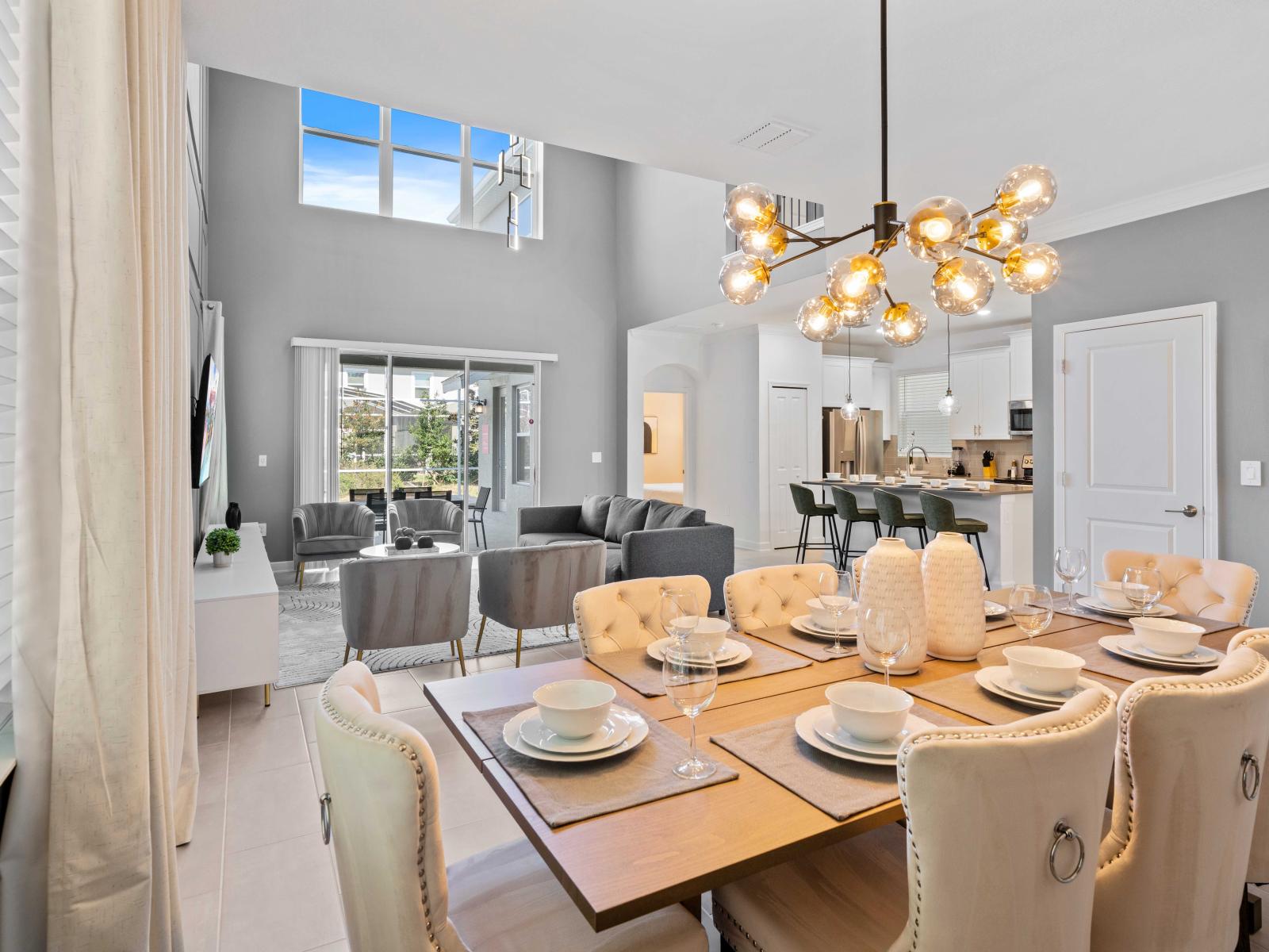 Luxury Home in Davenport Florida - Harmonious blend of living and dining spaces, providing  - Inviting atmosphere for both relaxation and shared meals - Cohesive design aesthetic carried through from furniture to window treatments