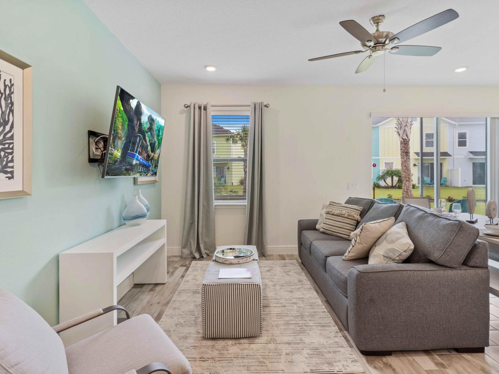 Alluring living area of the cottage in Kissimmee Florida - Plush gray comfy couch invites you to relax and recharge - Smart TV and Netflix - Ultimate comfort and elegance