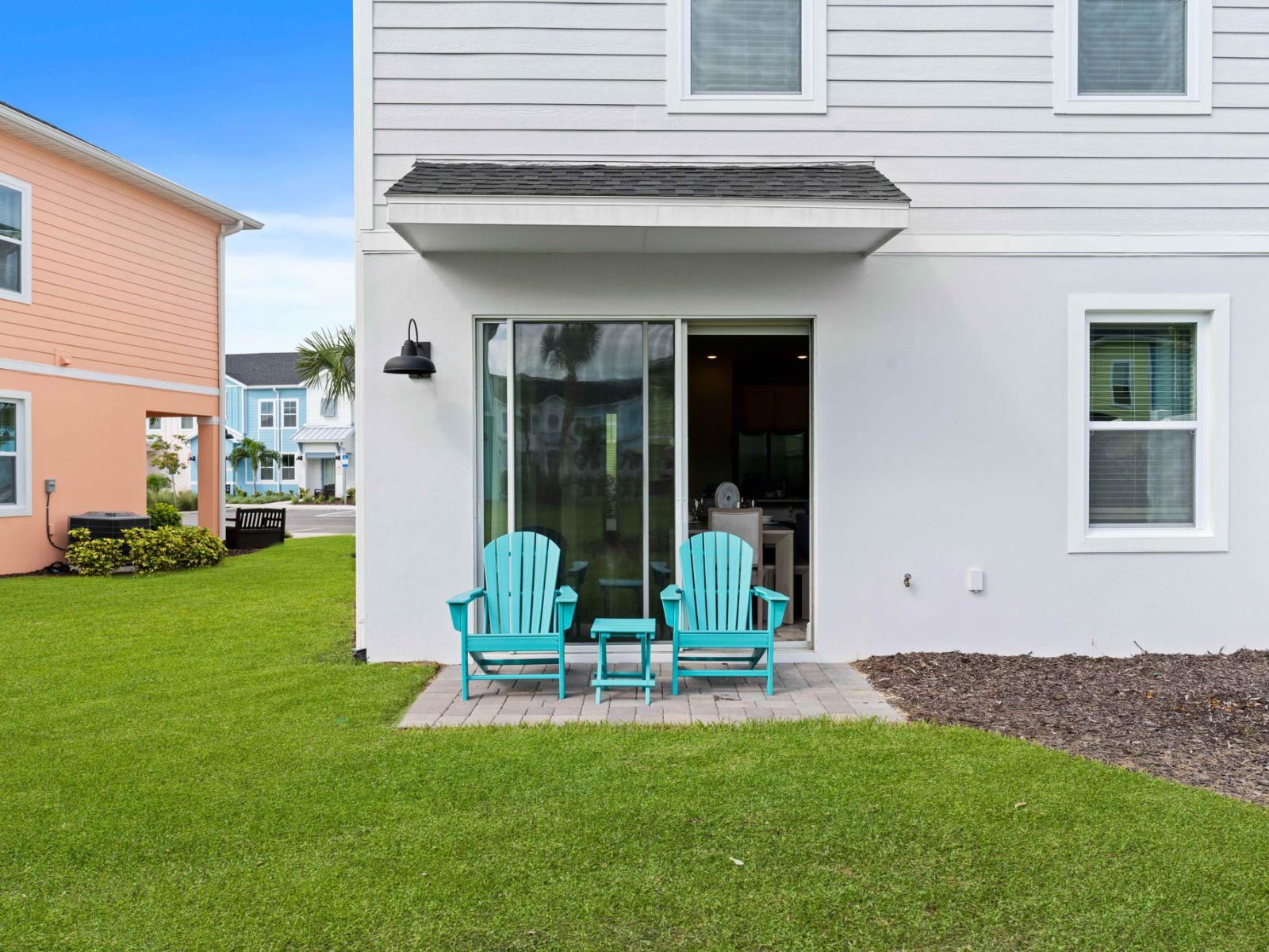 Calming outdoor seating area of the cottage in Kissimmee Florida - Enjoy a moment of tranquility on outdoor patio,  - Inviting chairs beckon for a leisurely afternoon in the sun