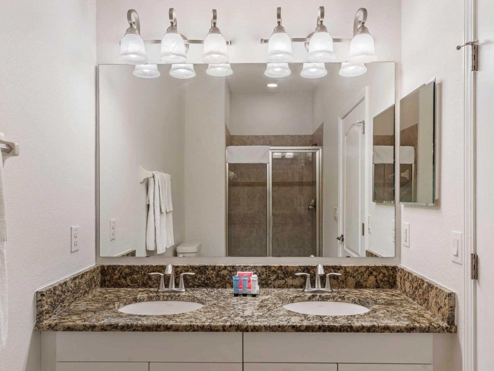 Chic bathroom of the townhouse in Kissimmee Florida - Walk-in Shower Area - Neat and Clean Bathroom  - Elegant lighting - Luxe dual vanity with large mirror