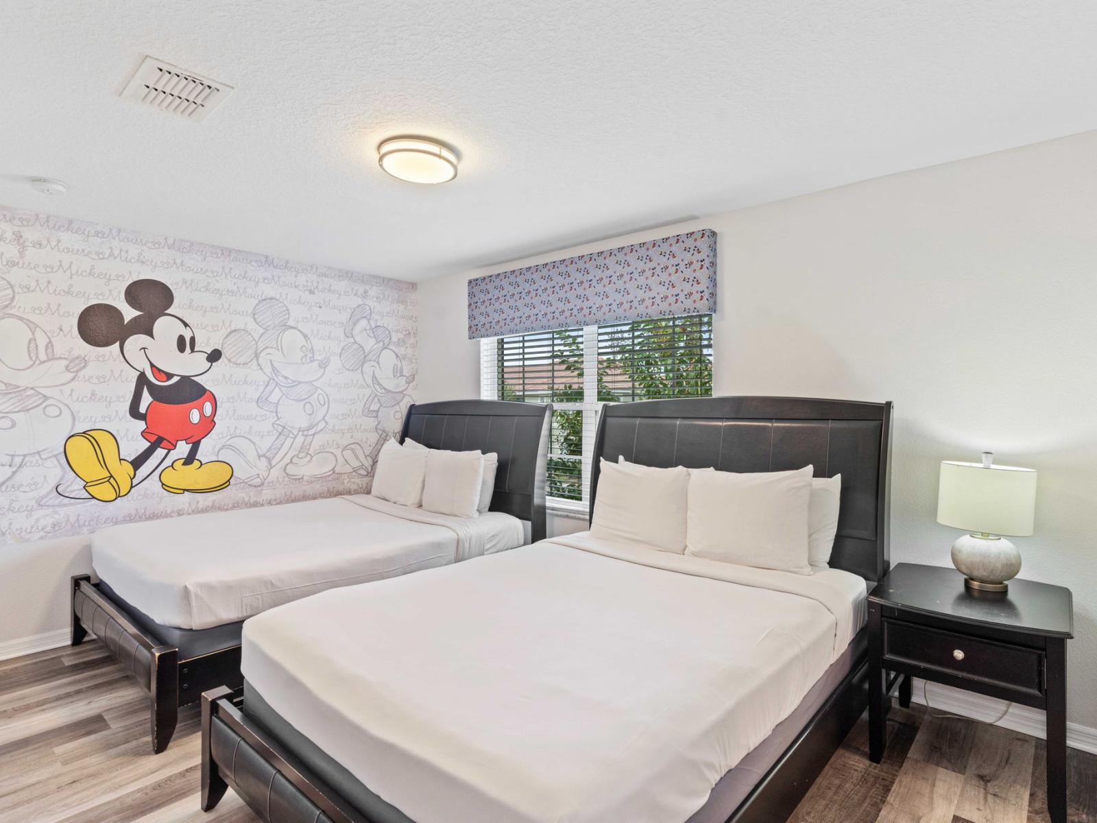 Micky mouse magic bedroom of the townhouse in Kissimmee Florida - Bedroom with a cozy ambiance, blending comfort and aesthetics - Two comfy double beds  - Adorned with cheerful mickey mouse wall accent