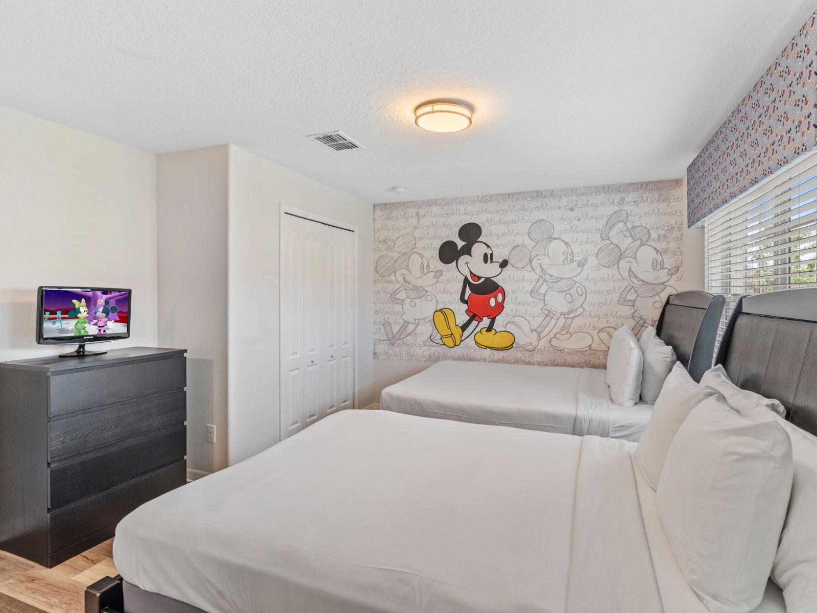 Immerse Yourself in the Magic: Discover Bedroom 3, Where Two Double Beds Await, Alongside a Private Bathroom Adorned with Cheerful Mickey Mouse Wall Accent.