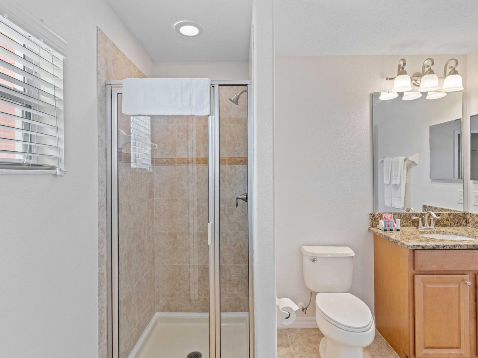 Unwind and Refresh in the Stylish Bathroom 3, Featuring a Walk-in Shower for a Relaxing Spa-like Experience.