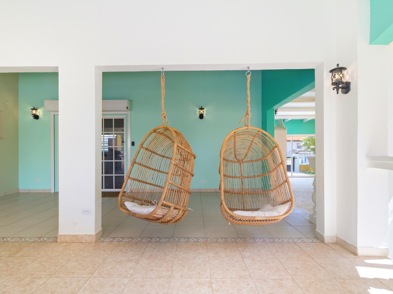 Beautiful 2 hanging chairs in the Terrace of the 3BR House in Noord, Aruba - Coolest way of relaxing in vibrant and refreshing atmosphere - Elegantly placed wall lamps - Refreshment according to you