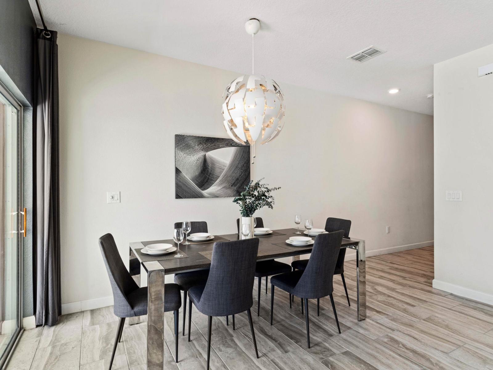 The dining area is tastefully adorned with gray-colored tables and chairs, exuding a sense of modern elegance and sophistication.