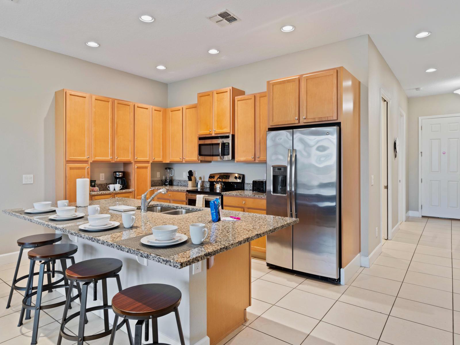 Chic Kitchen of the Townhouse in Davenport Florida - Functional layout designed for efficient meal preparation - Breakfast bar for additional workspace - High Chairs