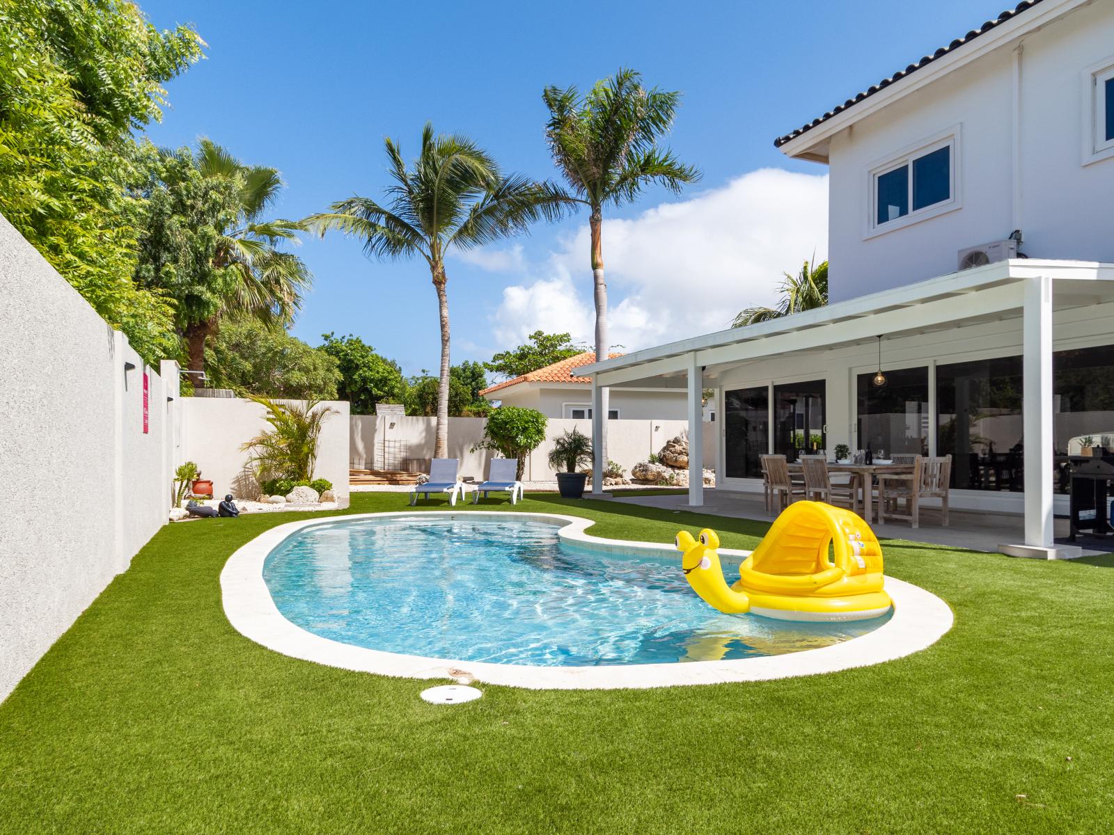 Chic Pool of the 5BR house in Noord Aruba - Some areas offer easy access to grills - Palm trees and tropical plants enhance the vacation feel - Maintained with clear guidelines