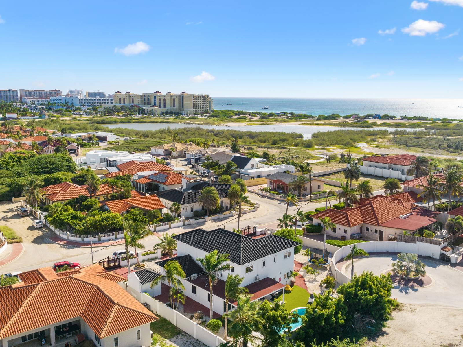 An aerial view demonstrating the home's proximity to high-rise hotels and its convenient location within the hotel district, as well as its close proximity to the beach.