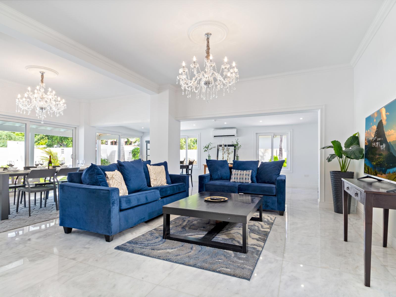 Glamorous living Area of the 5BR house in Noord Aruba - Thoughtful lighting design creates a warm and inviting ambiance. - Stylish color palette contributes to a harmonious atmosphere. - High ceilings creating an airy atmosphere - Smart TV and Netflix