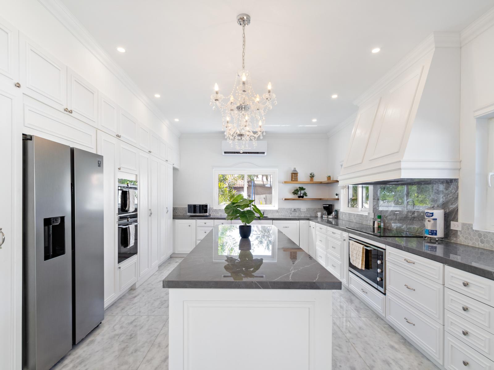 Modern Kitchen of the 5BR house in Noord Aruba - Well-lit space with strategically placed task lighting - Elegant and coordinated color palette for a cohesive look - Fully Equipped