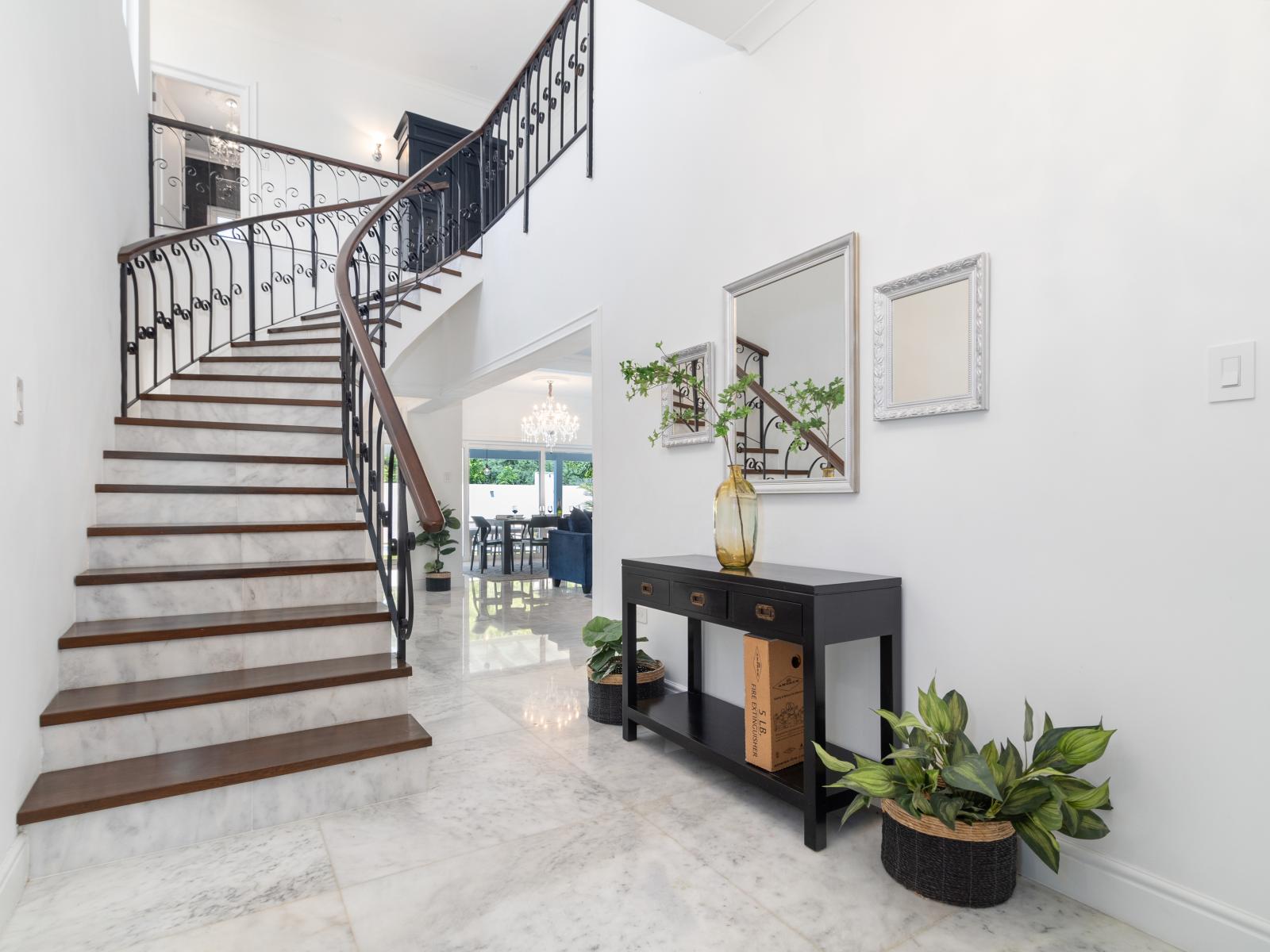 Ascend to elegance on our staircase to the second floor, adorned with a wooden railing and inviting lighting. Each step invites you to explore the upper levels of our home, where comfort and style await.