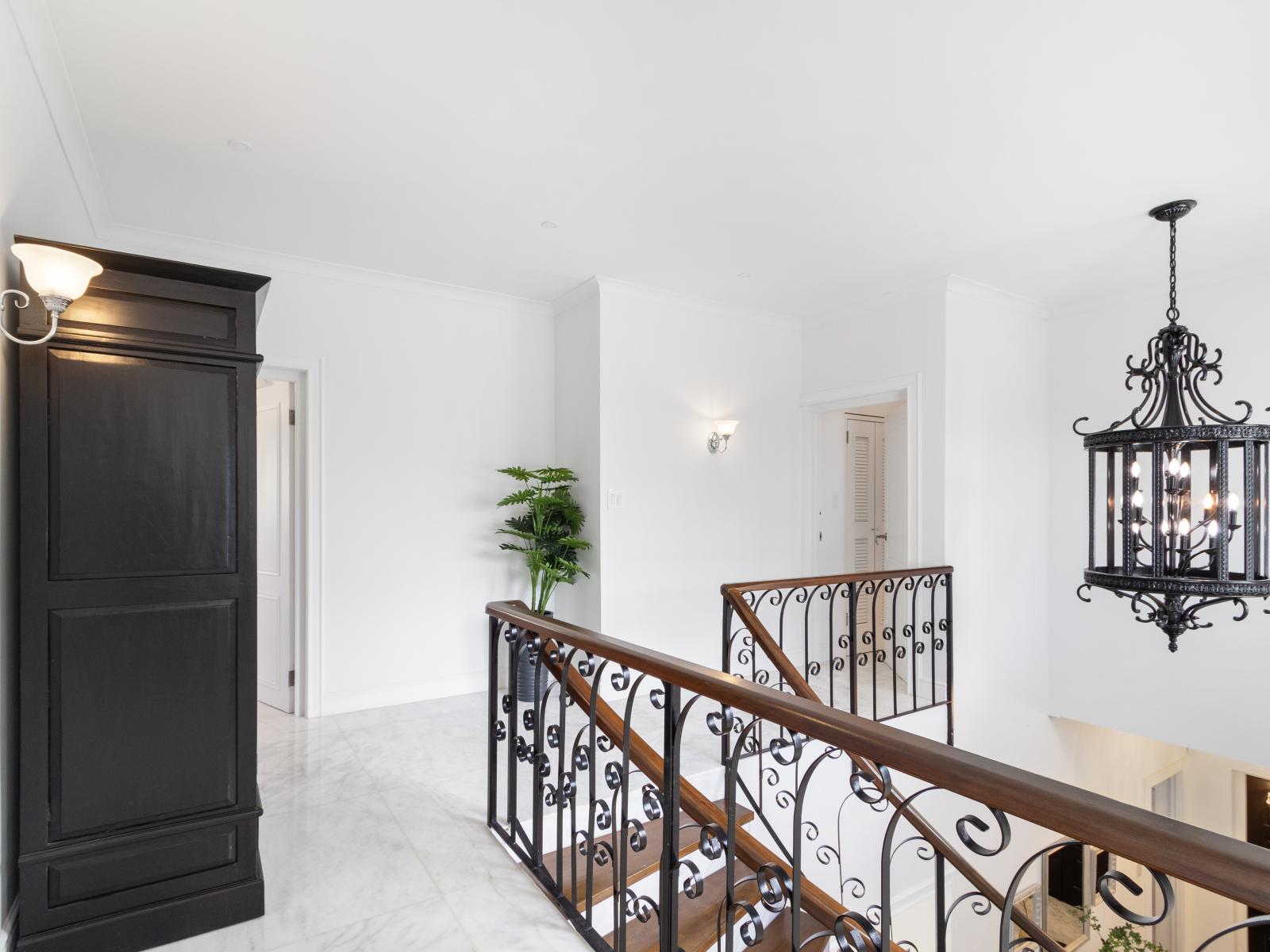 The hallway leading to the bedrooms and staircase, connecting the different areas of the home.