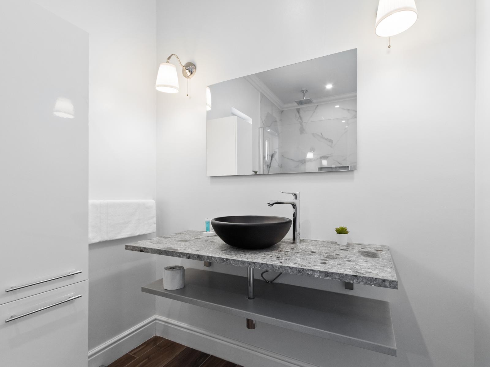 Step into luxury in bathroom two, where modern design elements elevate your daily routine. From sleek countertops to elegant lighting, every detail is carefully curated to create a spa-like atmosphere for ultimate relaxation.