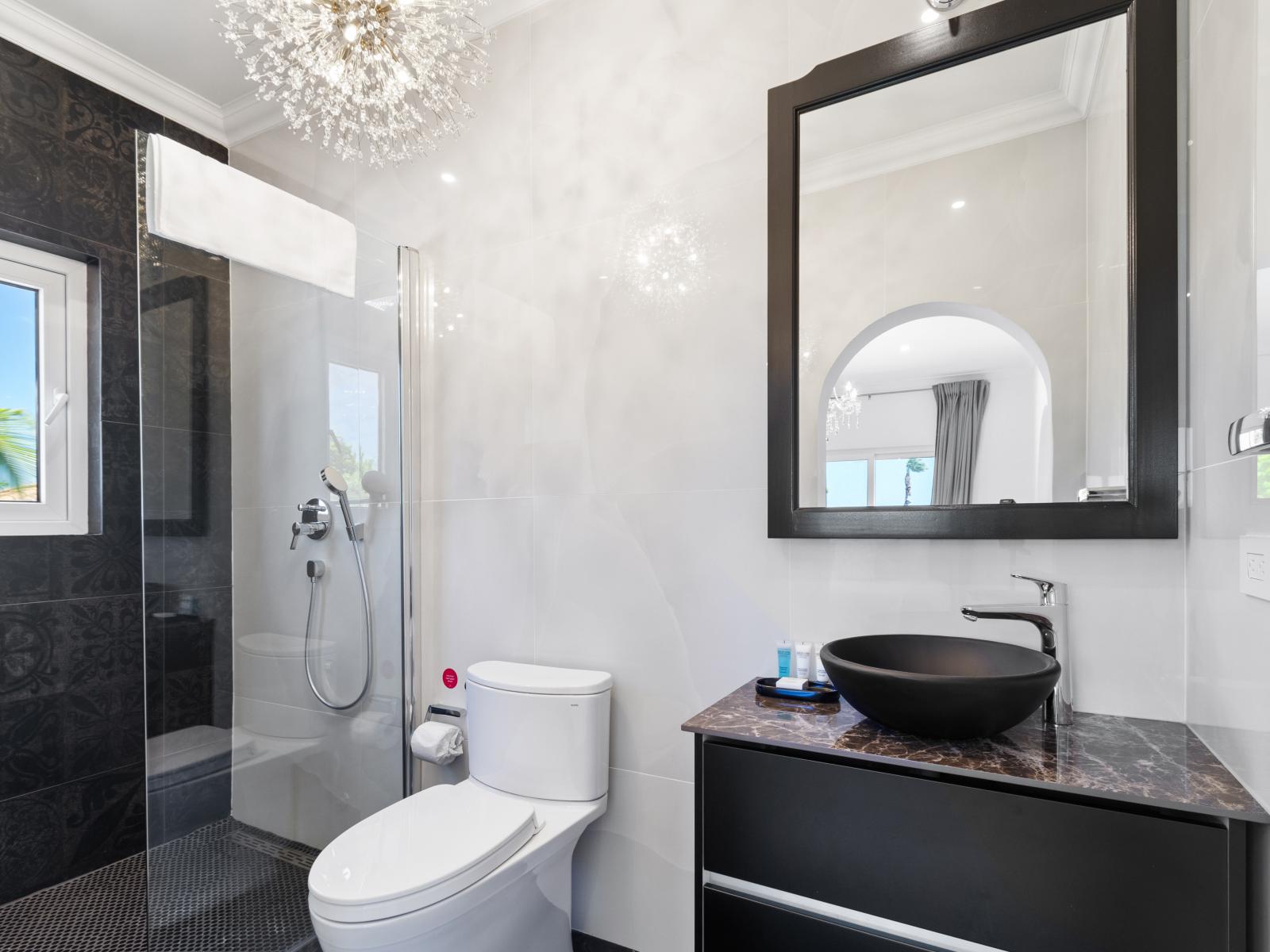 Step into elegance in bathroom three, boasting a stylish sink and rejuvenating shower. From the pristine fixtures to the invigorating ambiance, this space is designed for both functionality and relaxation.