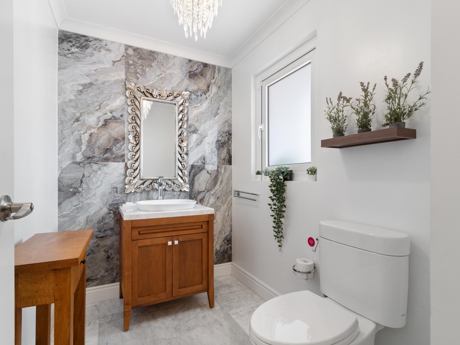 Experience the epitome of convenience in our half bathroom, designed for both practicality and style. From the sleek sink to the tasteful accents, this compact yet inviting space provides a refreshing retreat for quick refreshes and comfort.