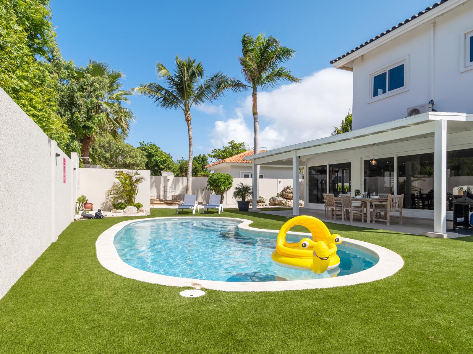 The pool, with its clear blue waters, promising a cool and inviting retreat.