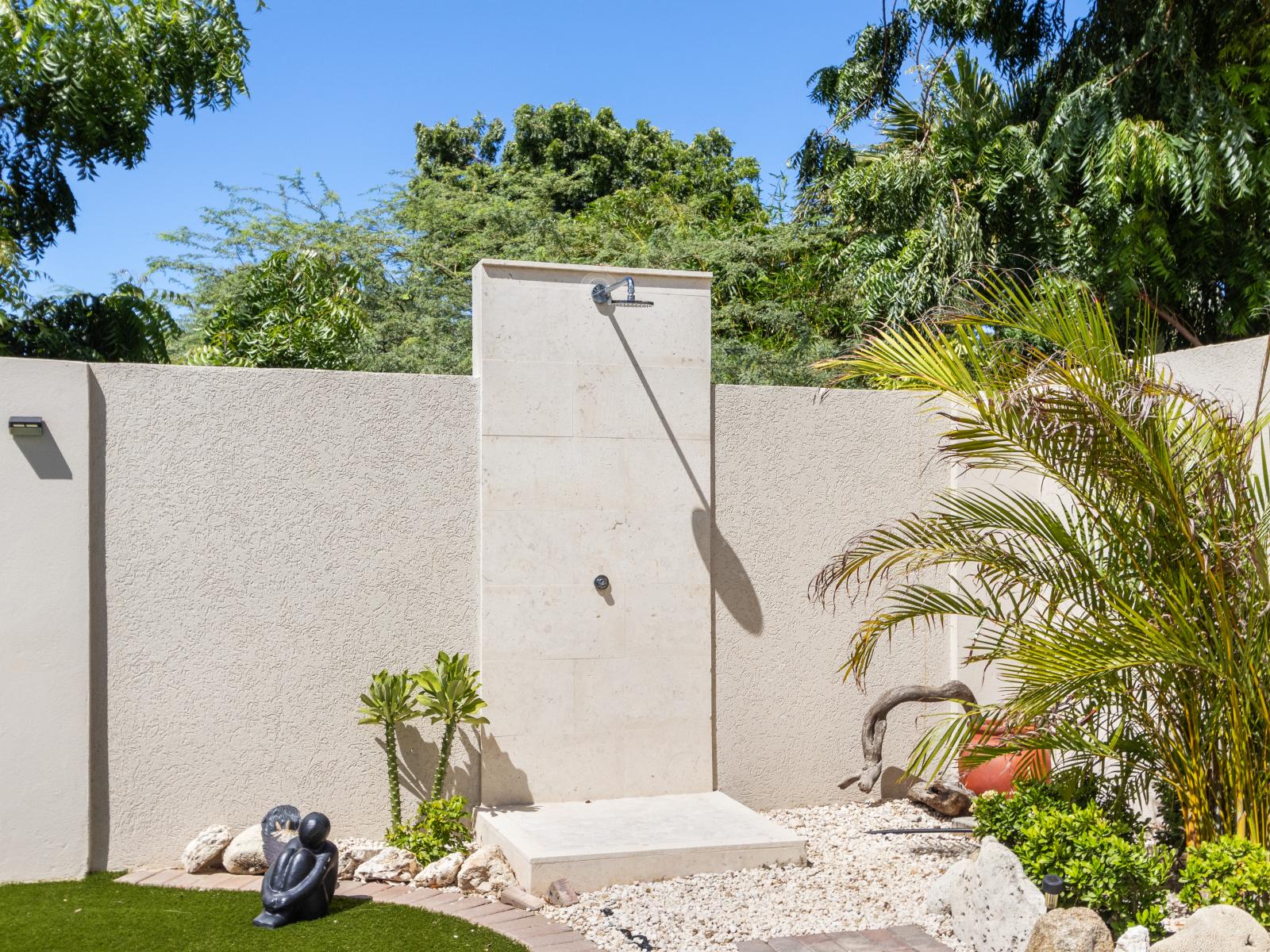 An outdoor shower, a convenient addition for rinsing off after poolside activities or enjoying the outdoors.