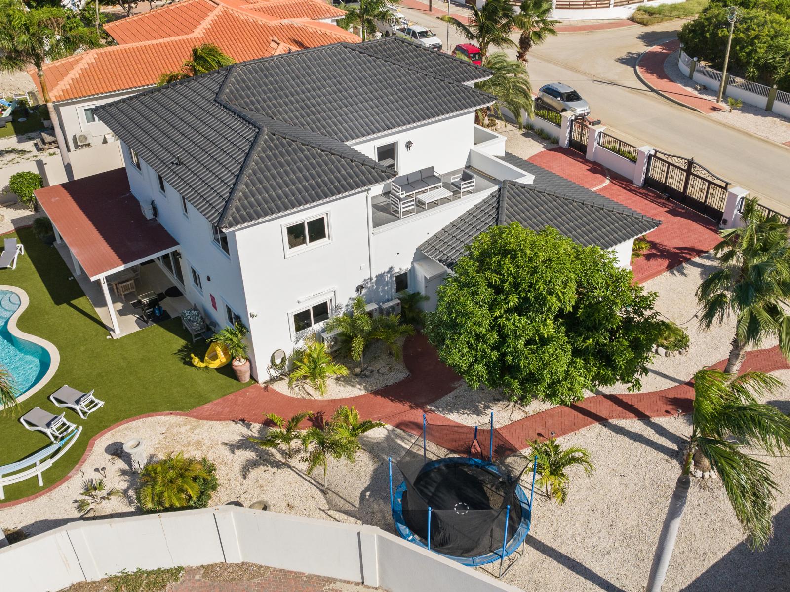 An aerial view showcasing the layout of the home's backyard, providing a comprehensive perspective from above.