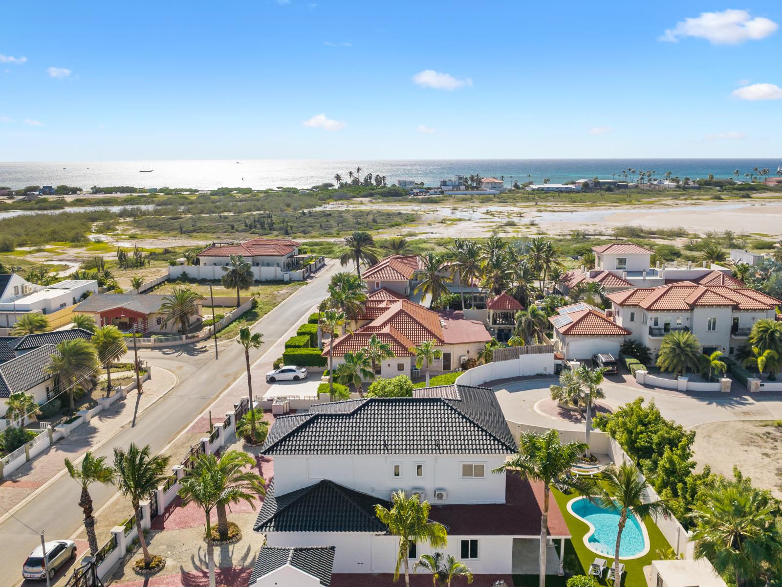 An aerial view of the home highlighting its close proximity to the ocean, offering a captivating perspective of the coastal location.