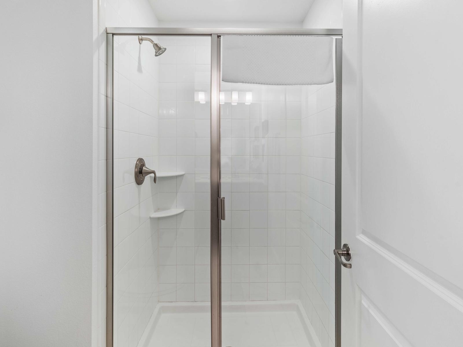 High-Class Bathroom of the apartment in Davenport - Beautiful Vanity with large size wall mirror - Sufficient storage space - Neat and clean toilet seat - Availability of all bathroom amenities - Stunning glass cabin shower area