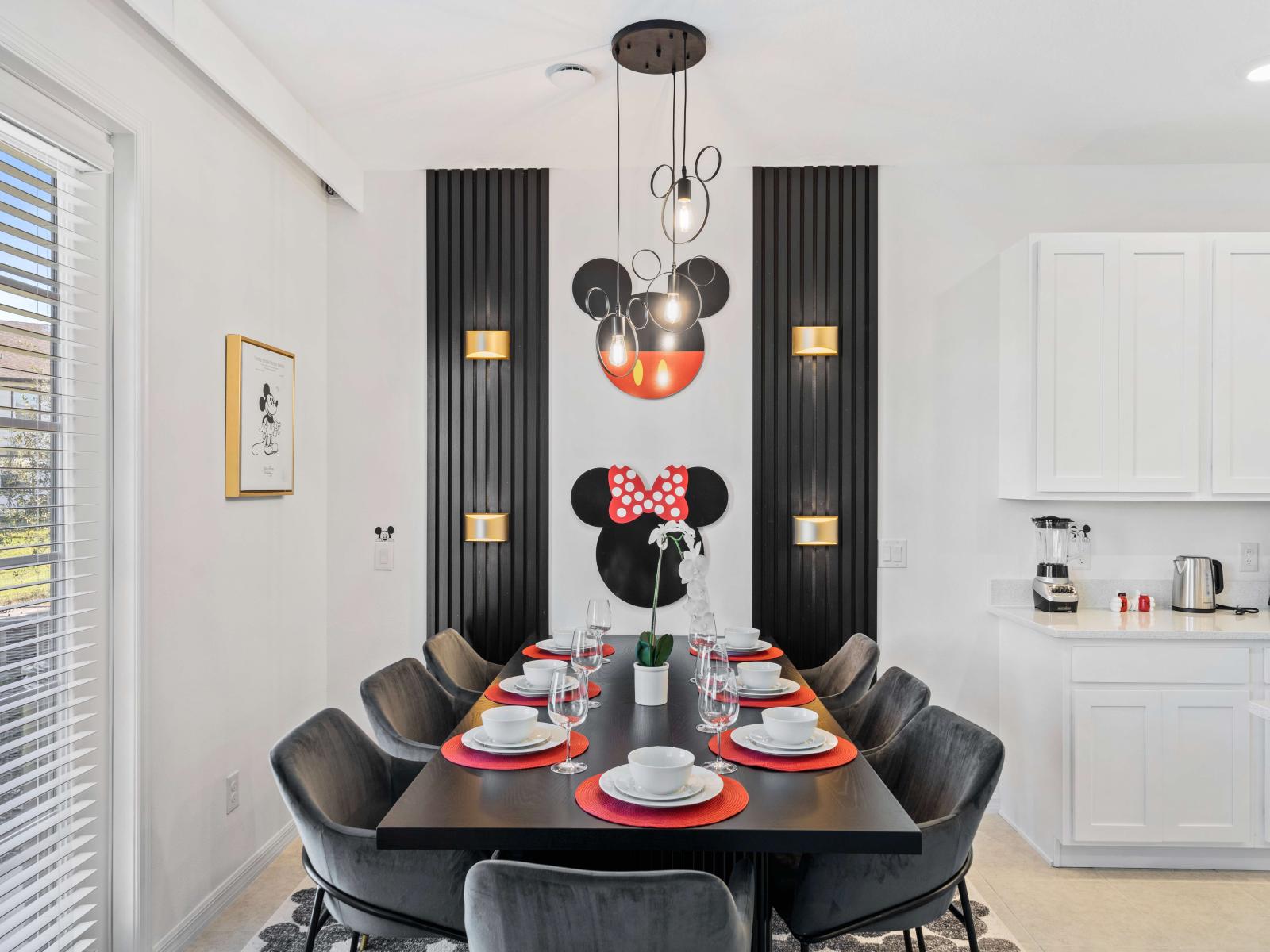 Micky's Dining Area of the Townhouse in Davenport Florida - The elegant dining area, adorned with Mickey mouse decor  - Exquisite lights and fixtures, exudes refined charm and beauty - Artfully arranged table settings for a touch of elegance