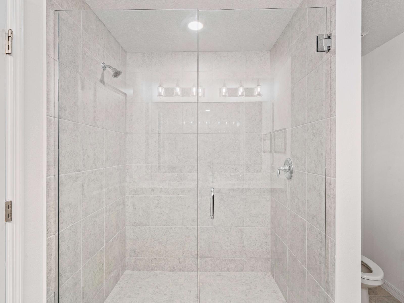 Stylish Glass-enclosed shower area of the Townhouse in Davenport Florida - A chic walk-in shower invites you to relax and rejuvenate - A serene setting