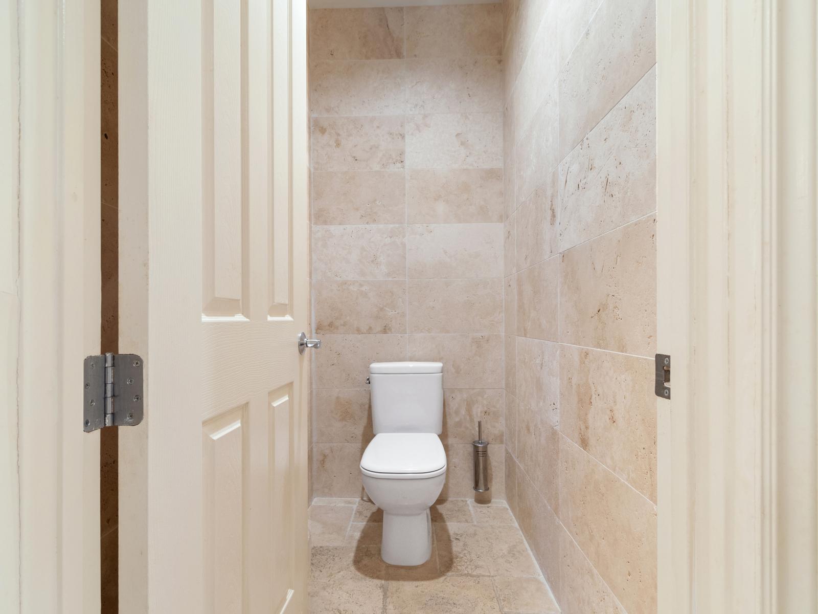 Experience convenience and comfort in our well-appointed bathroom, complete with a modern toilet. Enjoy peace of mind knowing that every detail of your stay has been carefully considered for your utmost comfort.